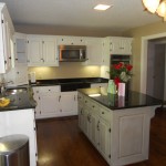 An after photo of this project with painted kitchen cabinets and contrasting island.