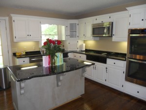 An after photo of this project with painted kitchen cabinets and contrasting island.
