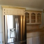 A before photo of this project with painted kitchen cabinets and contrasting island.